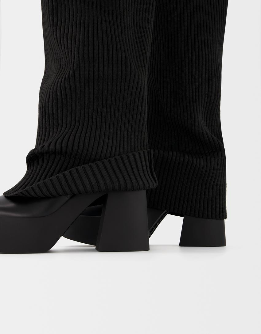 High-heeled platform boots with stocking detail